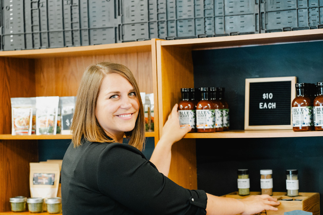 Bobbie Parr stocking the Parr's Jars salt lineup on the shop shelf